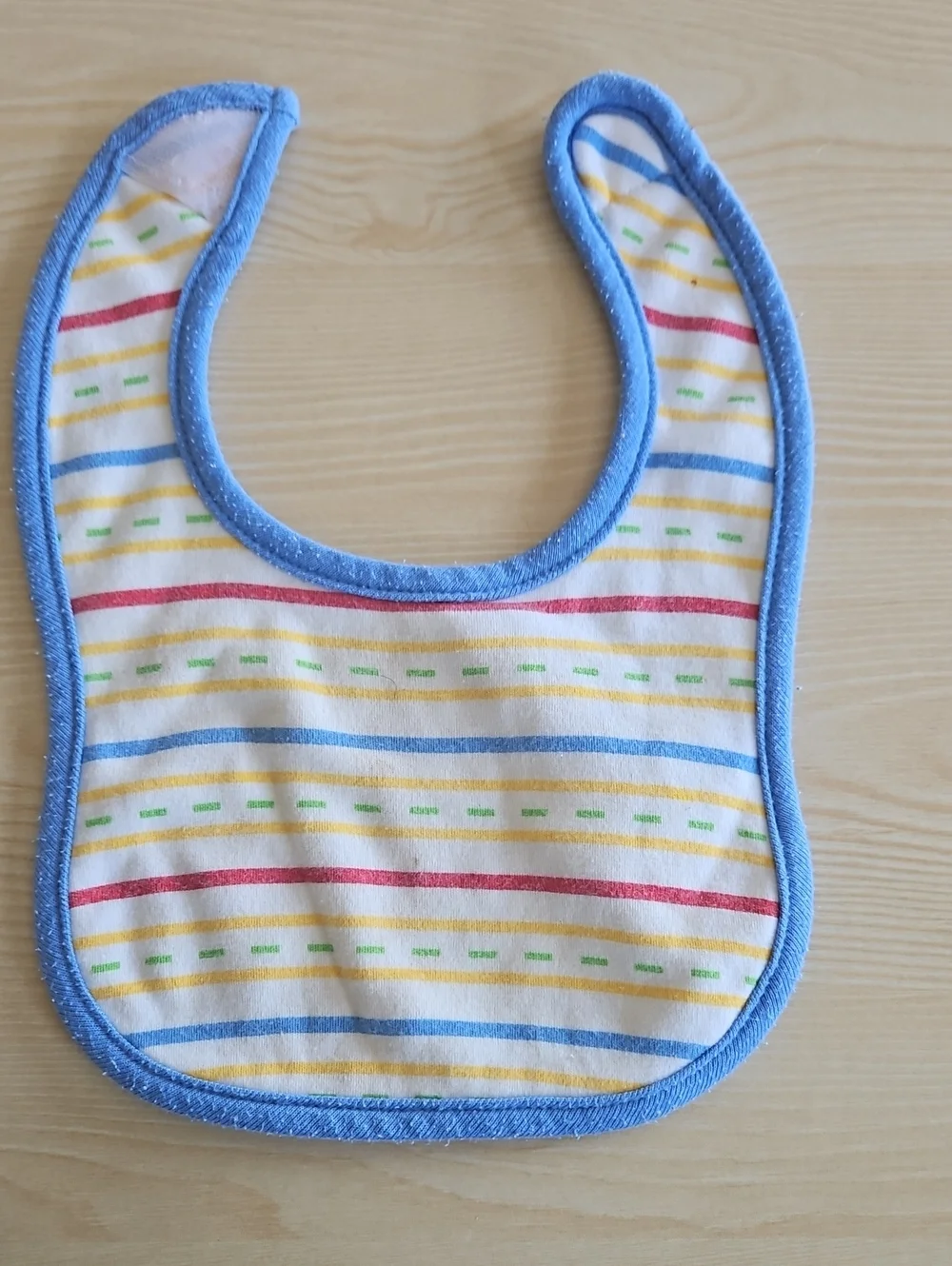 BabiesRUs Striped Bib with Blue Trim and Multicolor Lines